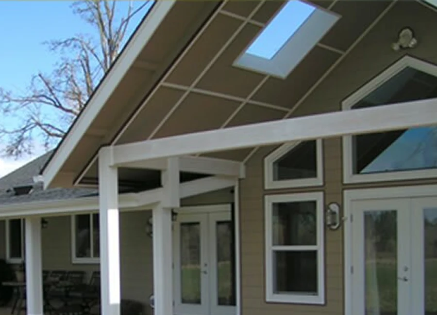 Covered outdoor structure with detailed beams and skylight